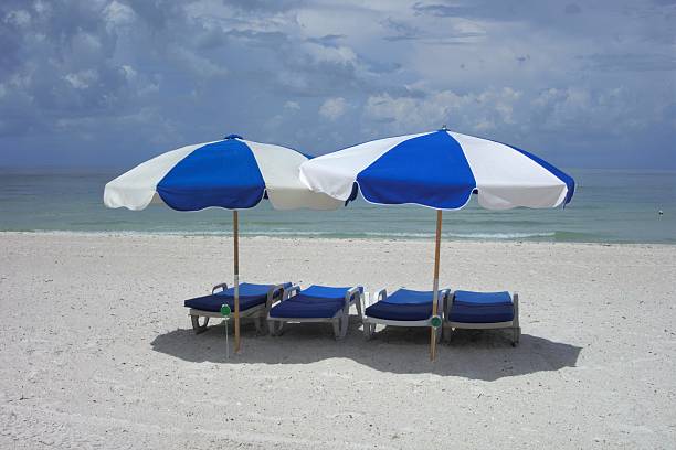 istock Beach chairs and sun umbrellas on white sand 532981120