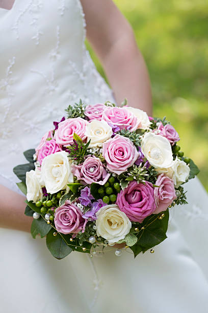 istock Bridal bouquet on white wedding dress 532981720
