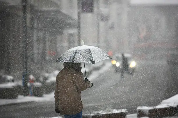 Photo of Man with umbrella during snow storm