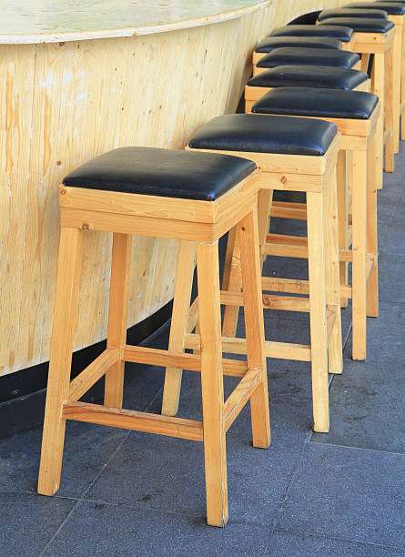 istock Lined up of wooden bar stools 532985425