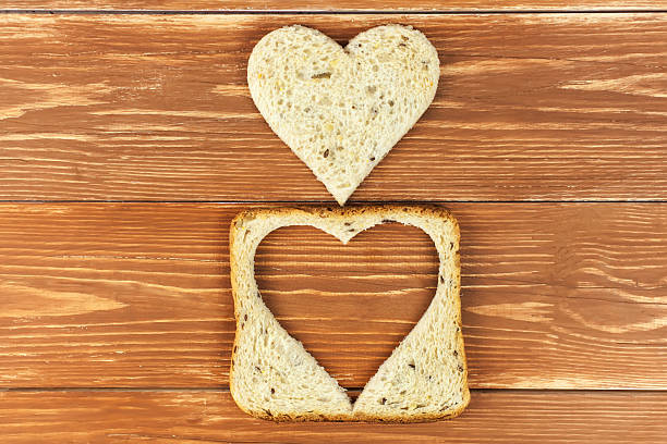 istock Slice of cereal toast bread with cut out heart shape 533004565