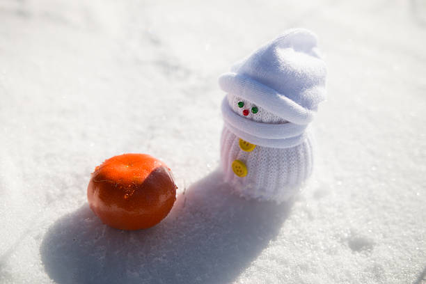 Baby-snowman and a tangerine
