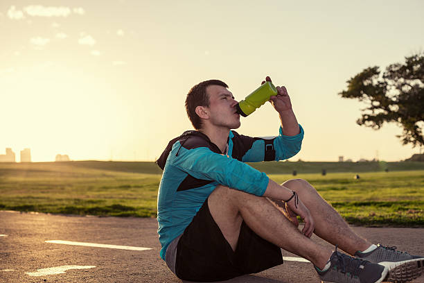 istock sportsman drinking water in the park 533029159