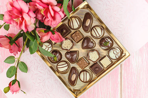 istock Box with chocolates and pink flowers. Selective focus. 533029261