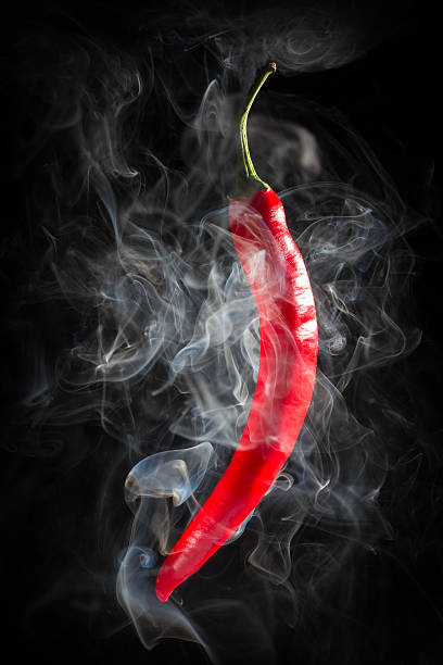 istock Smoking red hot chili Pepper on a  black background 533029593