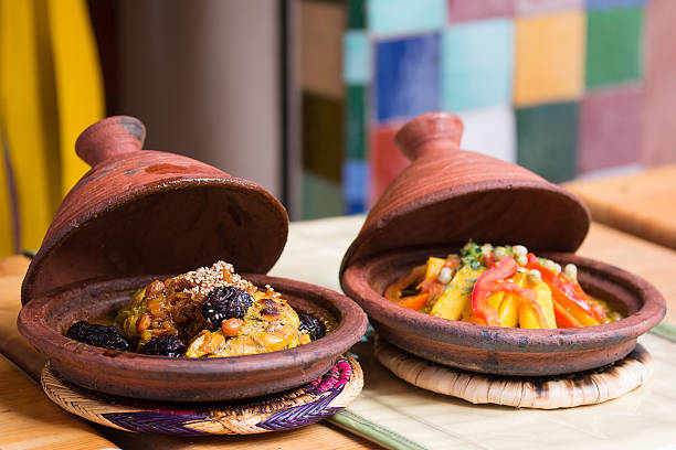 Morocco typical dish - meat and vegetable in a tajine. Morocco, Tajine of chicken with dried fruits - prunes and nuts. Traditional Moroccan gastronomic delicacy in ceramic tajine dish. tajine stock pictures, royalty-free photos & images