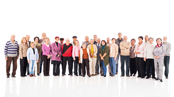 Large group of happy senior men and women looking at the camera. Isolated on white.