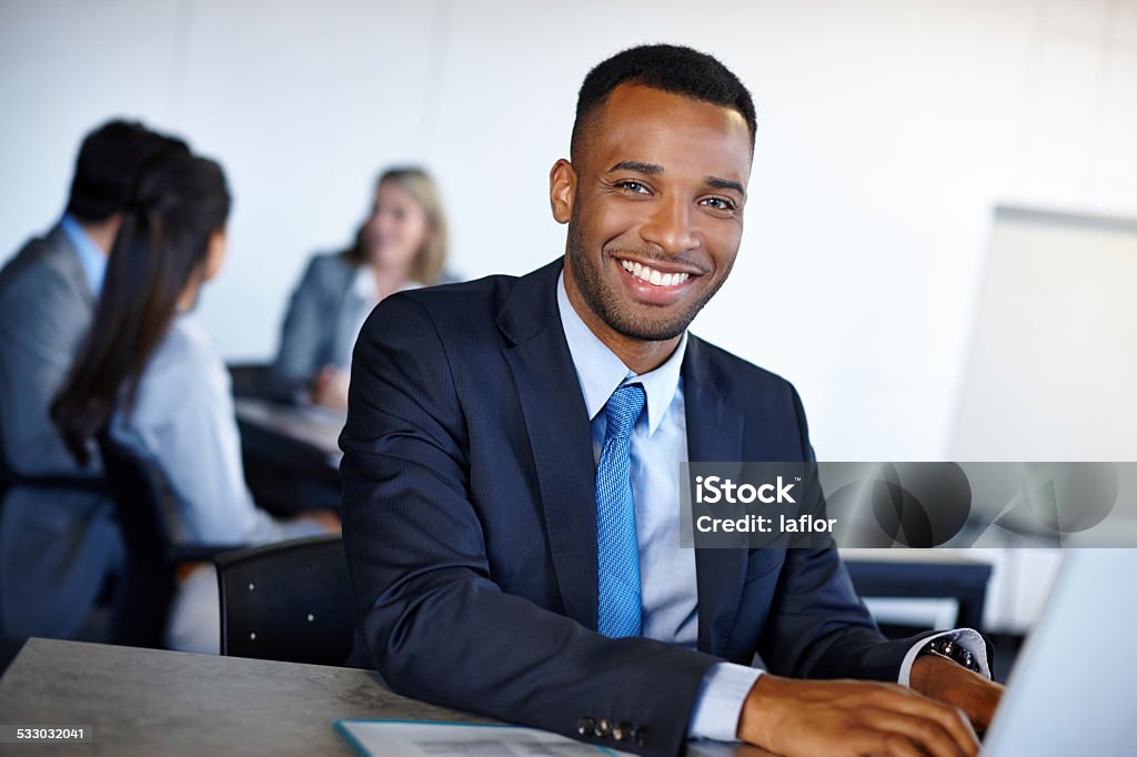 Learders are best when no one know they exist Shot of a handsome young businessman working on a laptop in the office 2015 Stock Photo