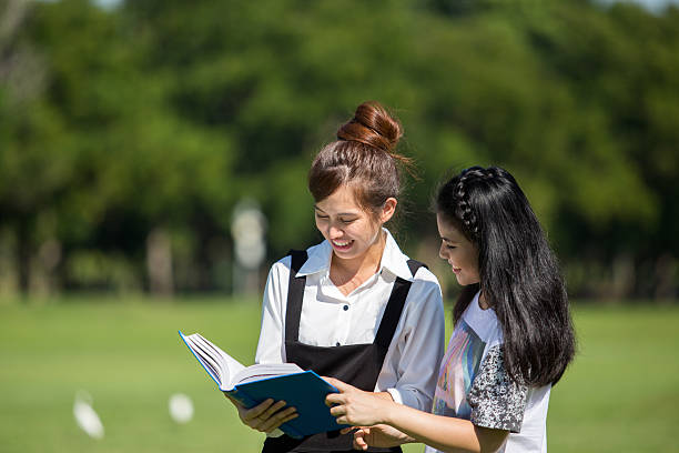 group of asian student in the park with book and lecture note Bangkok Thailand