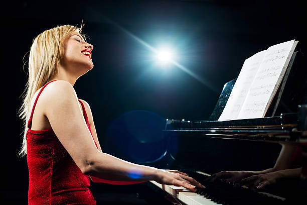 istock Happy woman playing piano. 533032473