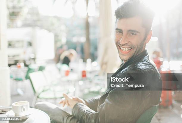 Young Man Sitting Outdoors Drinking Coffee Stock Photo - Download Image Now - 2015, Adults Only, Bar - Drink Establishment