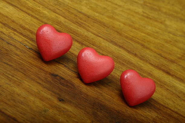 istock Three red heart on wooden background 533034073