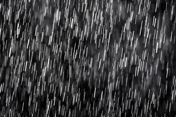 istock pouring rain againts black background. 533034203
