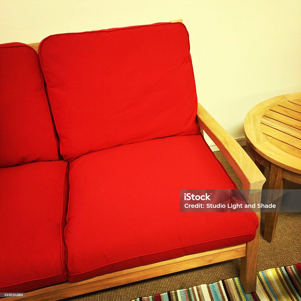 Red sofa and wooden table Bright red sofa and wooden table. Outdoor furniture. 2015 Stock Photo