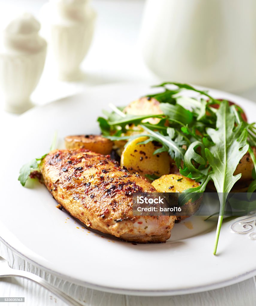 Spiced chicken breast with baked potatoes and arugula Spiced chicken breast with baked potatoes and arugula  Chicken Meat Stock Photo