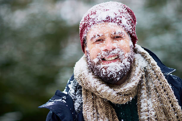 Frozen bearded guy Portrait of happy bearded man covered with snow frost face stock pictures, royalty-free photos & images