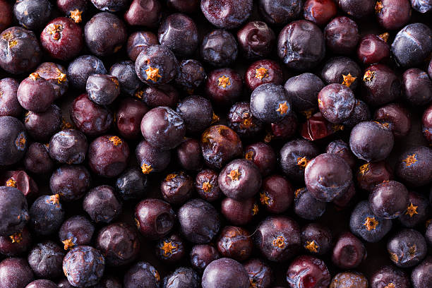 a heap of dried elderberries on dark background