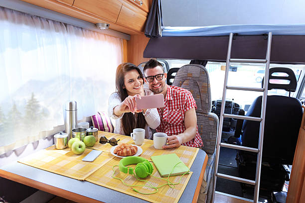 istock Smiling young couple making selfie in caravan 533042174