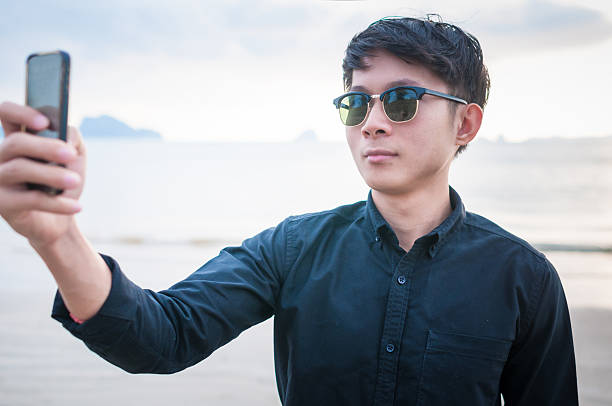 istock Business man working with smartphone beach background 533043196