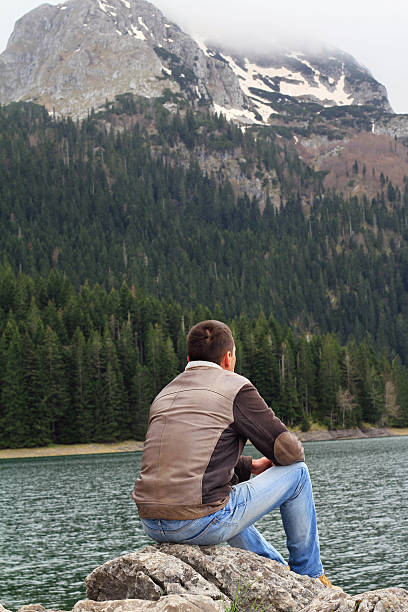 istock Traveler Man enjoying mountain lake view. 533045388