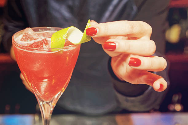 istock Female bartender is decorating a cocktail, toned 533045572