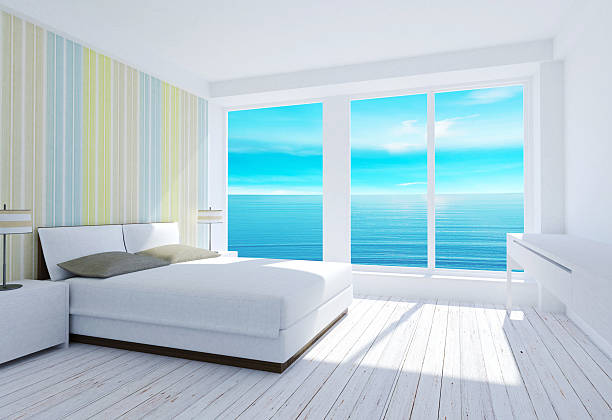 A coastal bedroom with ocean views from the window