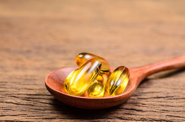 istock fish oil in wooden spoon 533047824