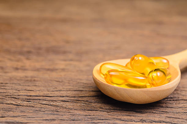 istock fish oil in wooden spoon 533047880