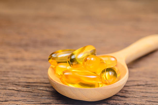 istock fish oil in wooden spoon 533047944