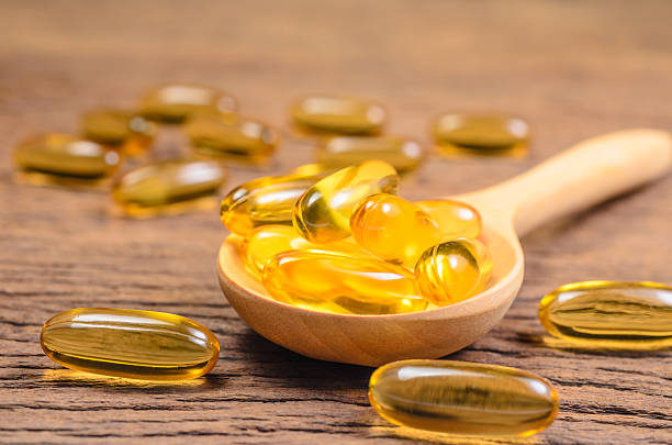 istock fish oil in wooden spoon 533048056