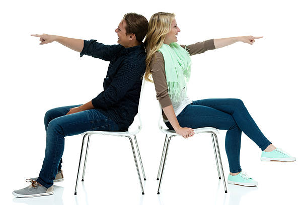 istock Happy couple sitting on chair and pointing 533048426