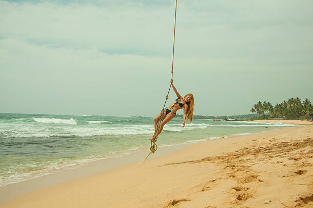 istock Woman swinging at beach 533048546