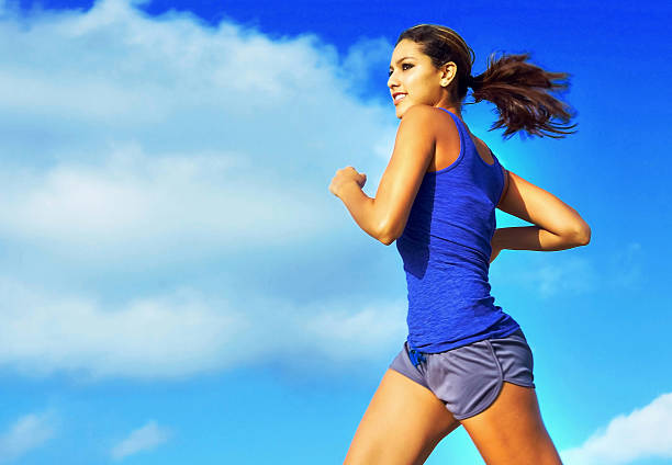 istock Fit Young Woman Jogging Against Cloudy Sky 533048567