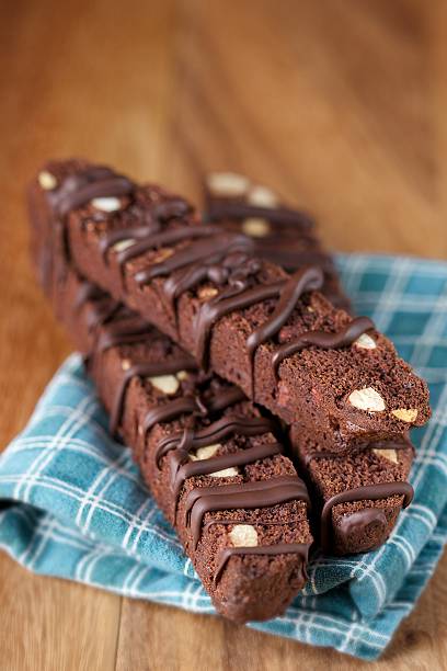 istock Three Stacked Chocolate Almond Biscotti on Wood with Napkin 533049585