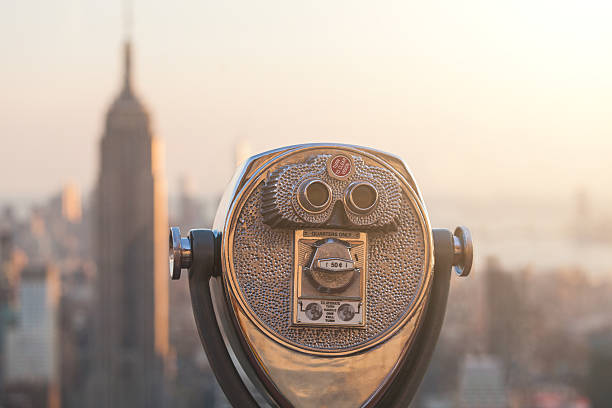 istock Binocular with New York Skyscrapers on Background at Sunset 533049637