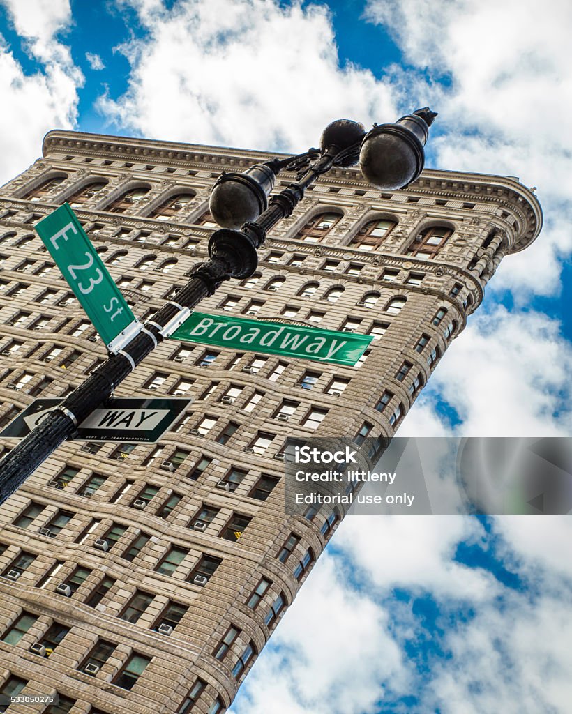 Flatiron NYC New York City, New York, USA - January 9, 2015: Iconic Flatiron Building in Midtown Manhattan with Broadway and 23rd Street sign in view.  This historic skyscraper was completed in 1902.  2015 Stock Photo