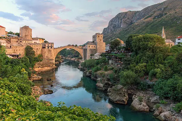 Evening scene in Mostar with the medieval town and the historic bridge over the Neretva river in Bosnia Herzegovina.
