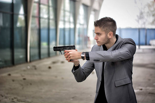 istock Detective, mobster or policeman aiming a firearm 533051247