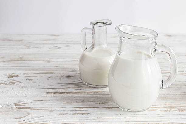 istock Milk jars on wooden background 533051656