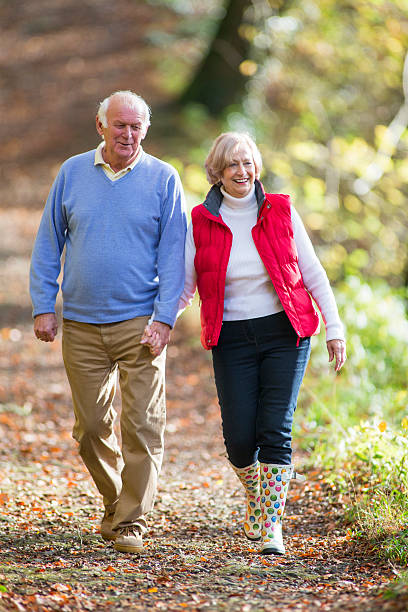 istock Senior Couple Walking Through the Woods 533051657