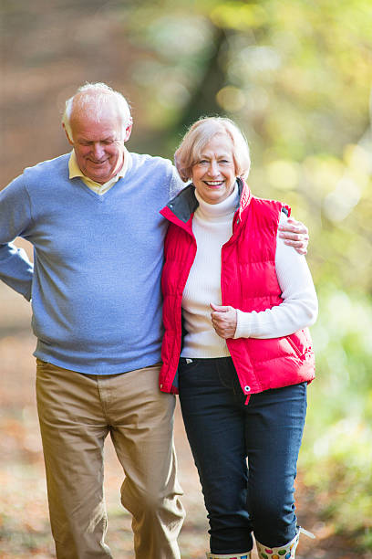 istock Senior Couple Walking Through the Woods 533051659
