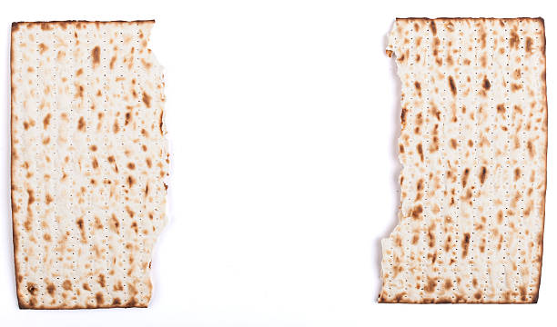 Broken Matza Broken in half Jewish traditional Pesach textured Matza bread substitute isolated on white background hebrew script photos stock pictures, royalty-free photos & images
