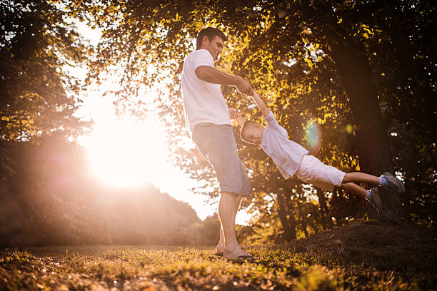 istock Father and son having fun at sunset. 533052137