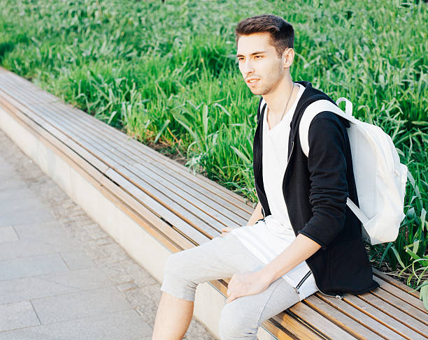 istock Young male traveler is resting on the bench 533052426