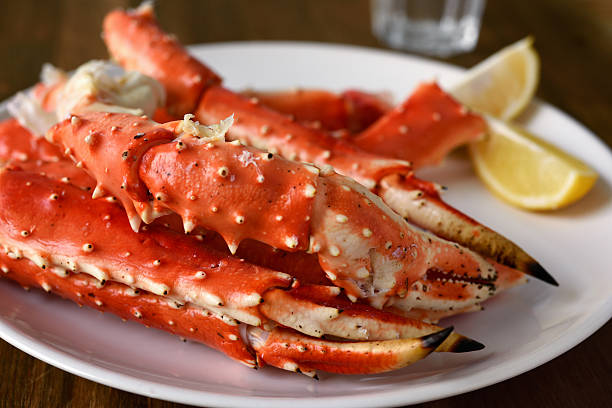 Red king crab legs Red king crab legs with lemon on a plate crab leg photos stock pictures, royalty-free photos & images