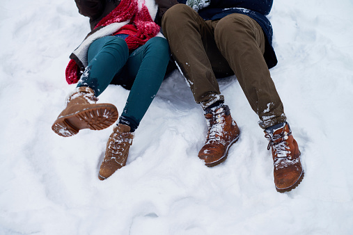 Low section of couple falling in snow