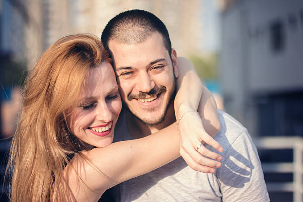 istock Happy couple cuddle outdoors 533053894