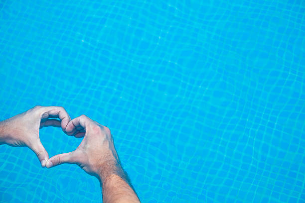 istock Hands in heart shape in a swimming pool. 533053957