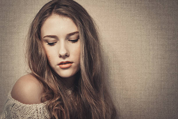 istock Young beautiful girl looking down, studio portrait 533054219