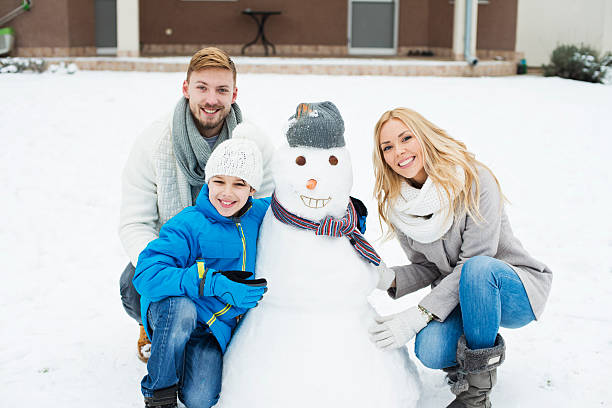istock Cute family portrait with snowman 533054501